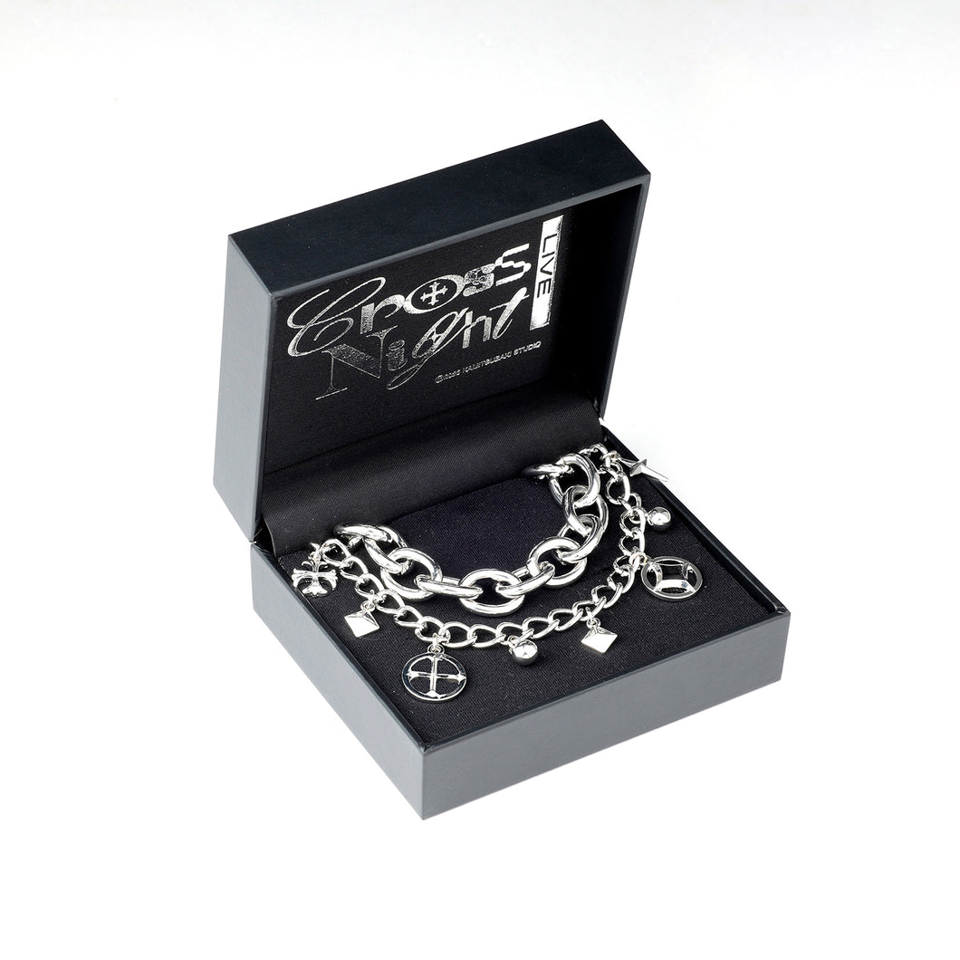 Chain bracelet with charms displayed inside a black Cross Night LIVE branded presentation box.
