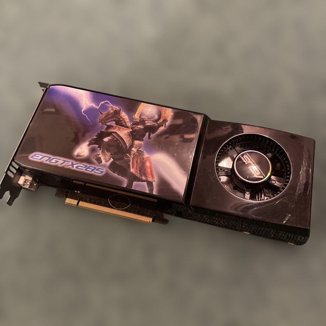 Photo of an ASUS ENGTX285 graphics card showing the fan, shroud artwork, PCIe connector, and DVI ports.