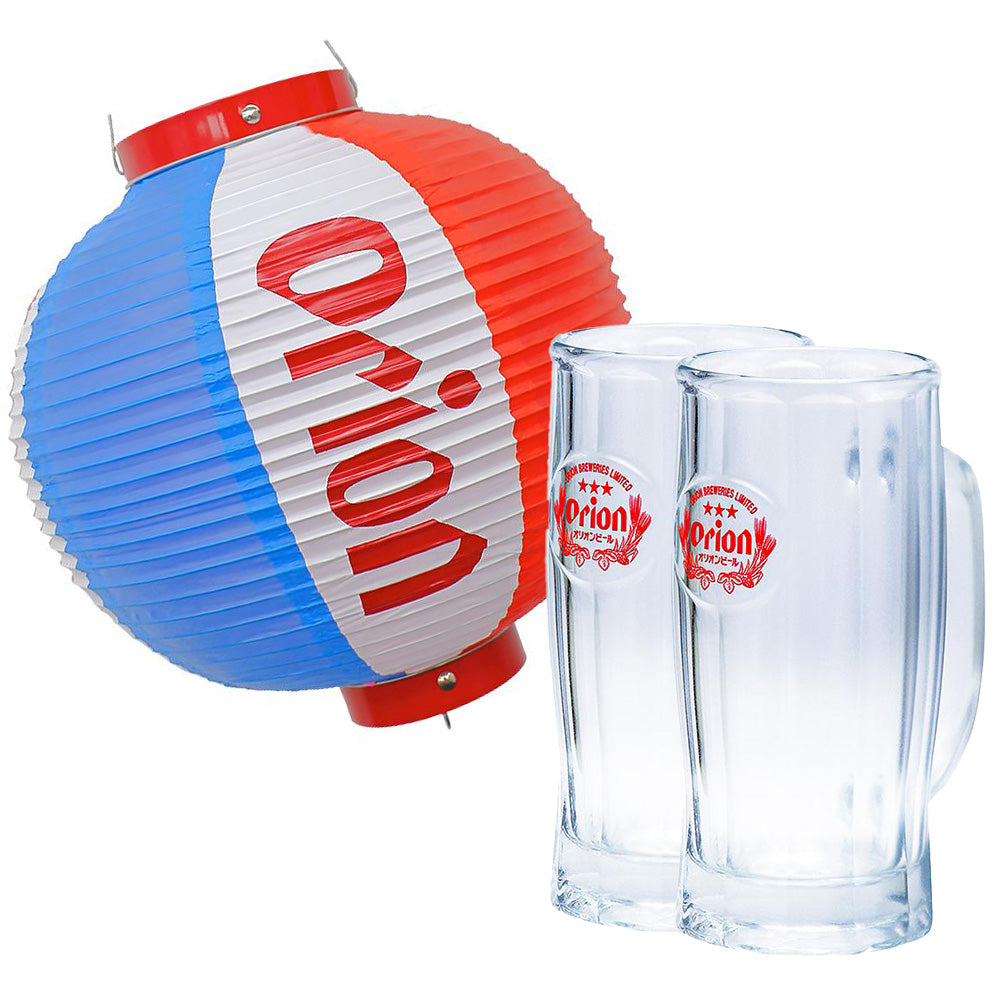 Two clear glass beer mugs with Orion logos next to a red-and-blue Orion paper lantern.