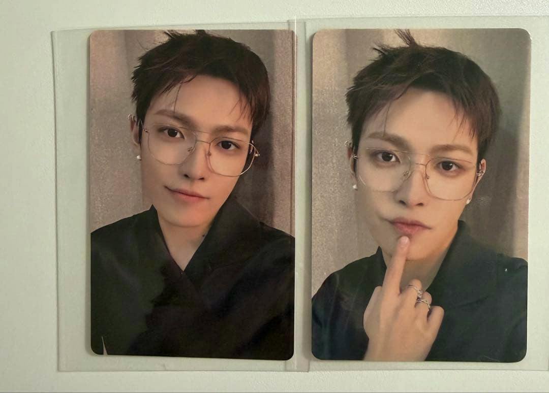 Front sides of two ATEEZ "ATINY'S VOYAGE" photocards placed side by side, each showing a portrait of the card subject wearing glasses.