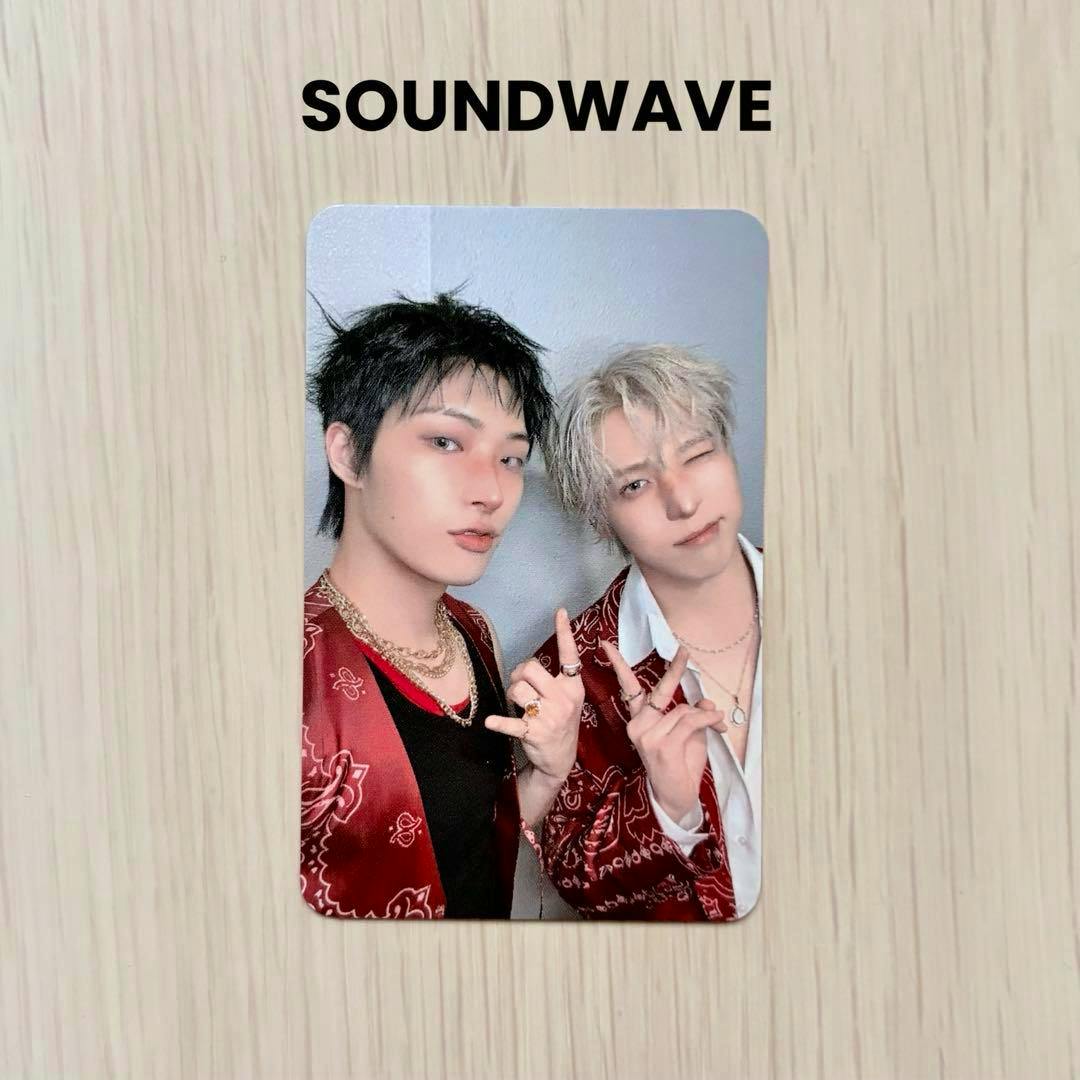 Photocard showing ATEEZ members Mingi and Yuno posing together, placed on a light wood surface with the word "SOUNDWAVE" above.