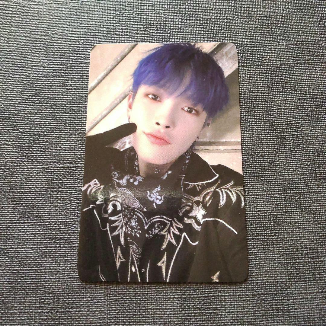 Close-up photo of one photocard from the ATEEZ OUTLAW set showing a blue-haired member on a gray textured background.