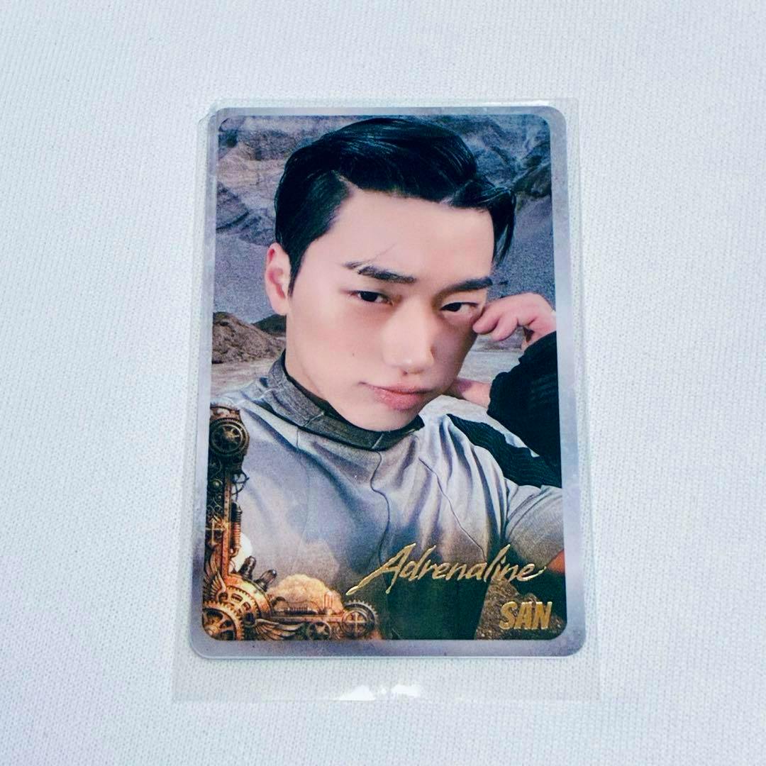 Photocard for ATEEZ GOLDEN HIGHER TIMEPIECE showing a head-and-shoulders portrait of a member in a plastic sleeve with gold "Adrenaline" text and decorative gear motifs.