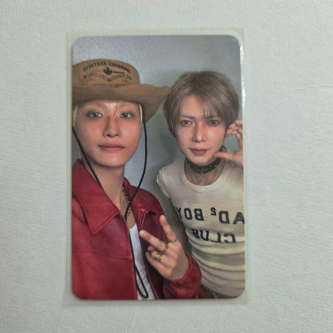 Photocard for ATEEZ showing two members posing together, one wearing a cowboy hat and red jacket and the other wearing a white t-shirt, photographed on a white background.