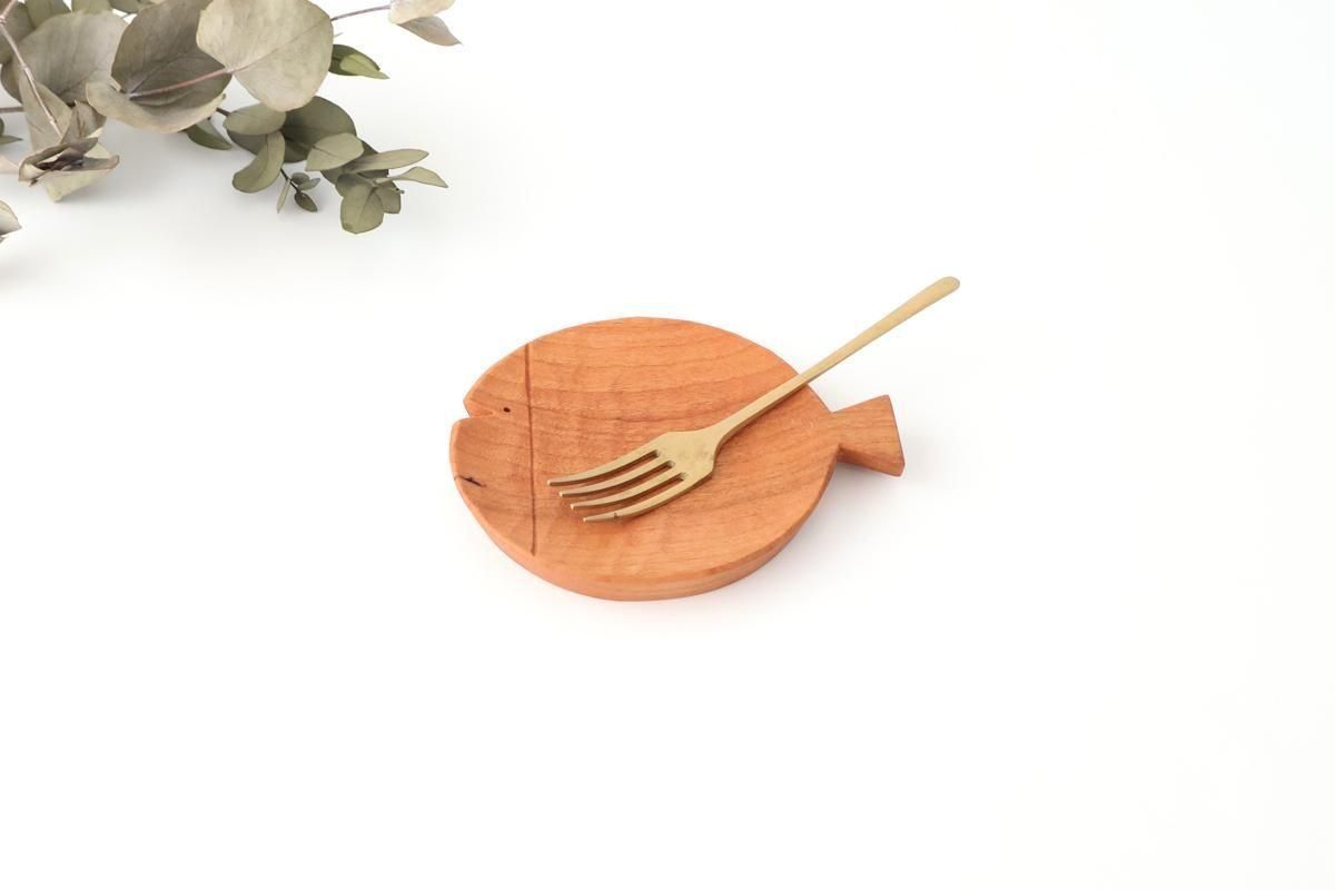 Cherry wooden fish-shaped 90mm plate on a white background with a small fork resting on it.