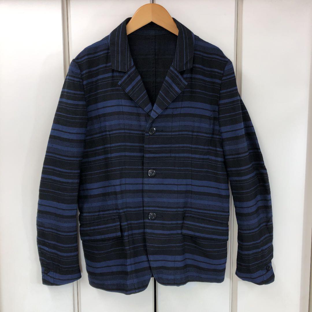 Front view of the men's wool ATTACHMENT multi-striped 3-button jacket in blue and black hung on a hanger.