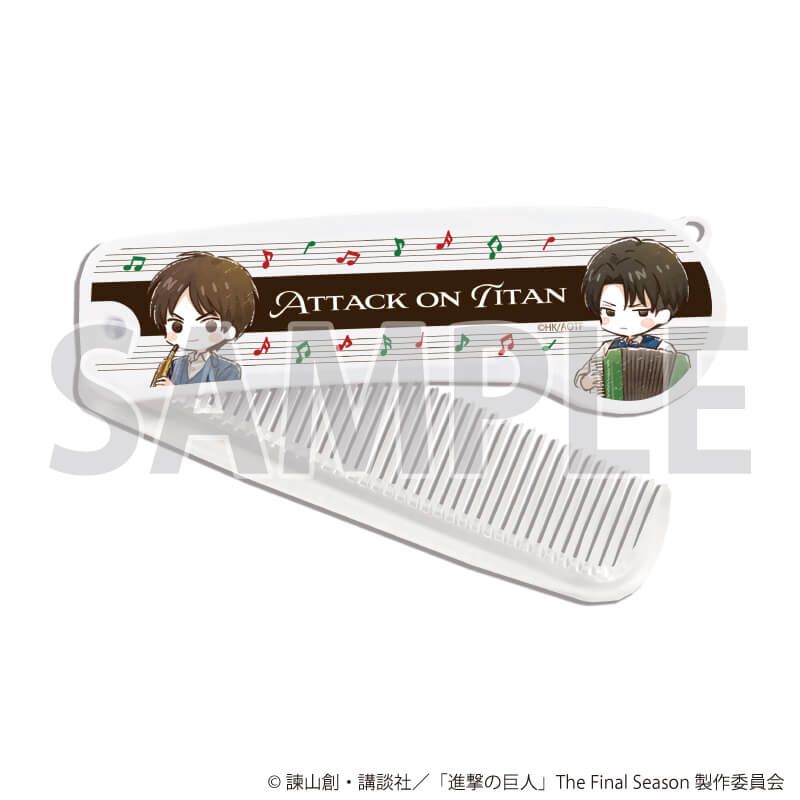 Foldable comb showing chibi Attack on Titan characters playing instruments, musical notes, and the text "Attack on Titan."