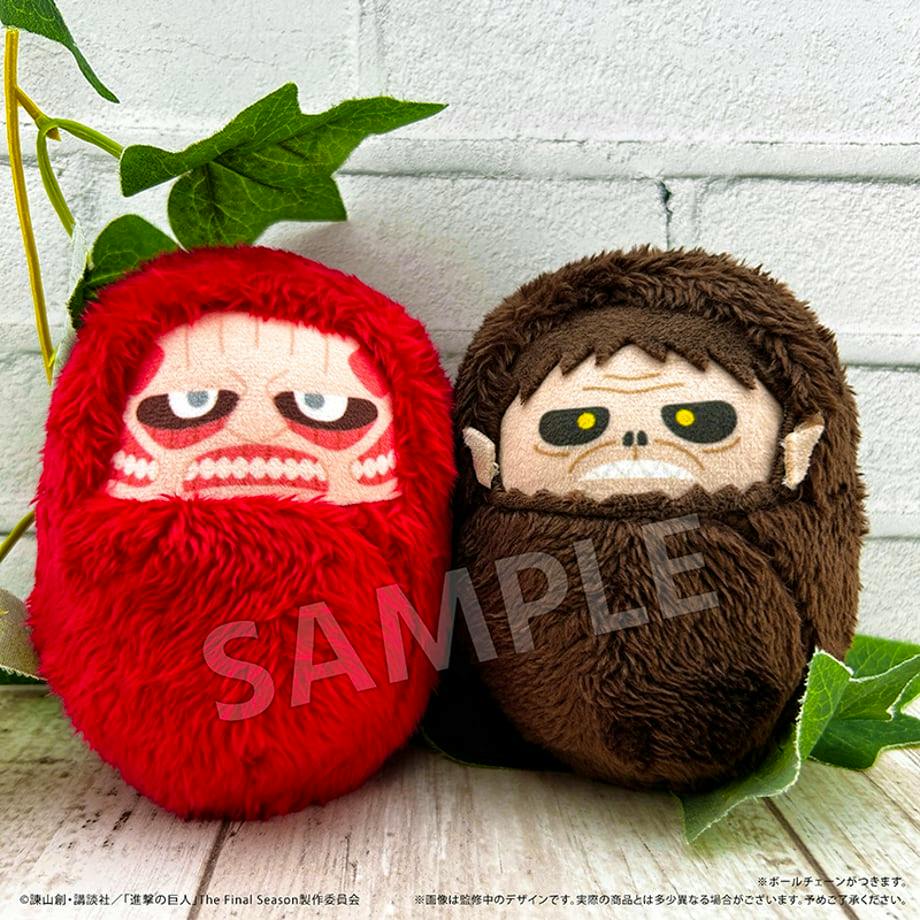 Two plush titan toys, one red and one brown, shown side by side against a light background.