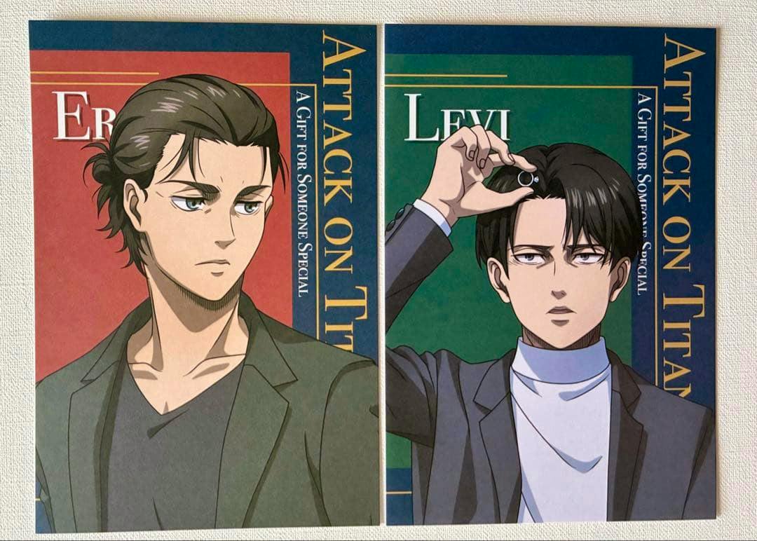 Photo of two Attack on Titan postcards side by side featuring Eren (left) and Levi (right) character illustrations.