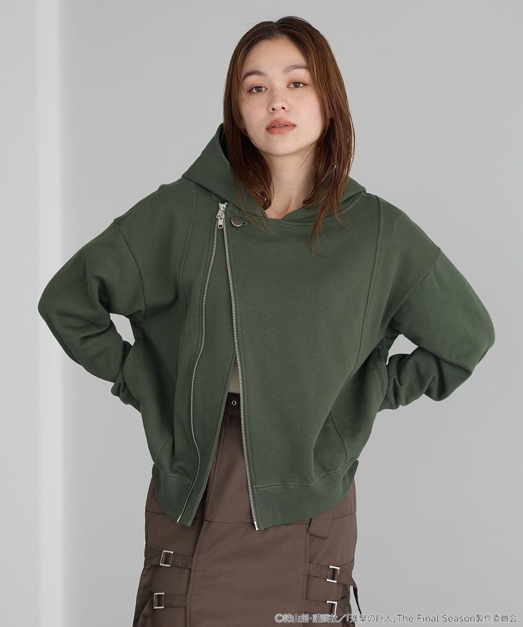 A model wearing a green cotton hooded sweatshirt with an asymmetrical front zipper.