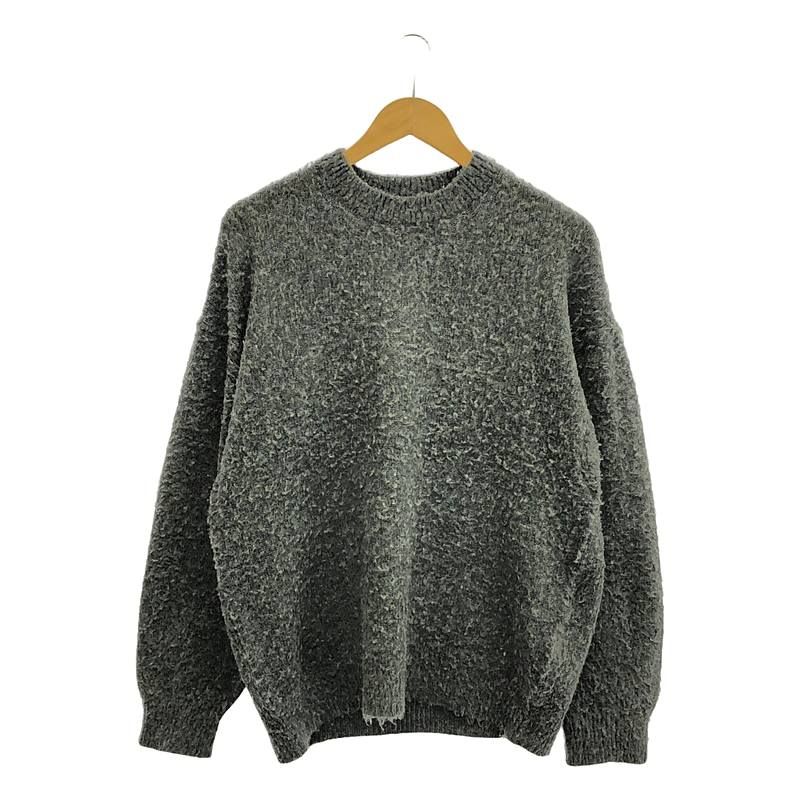Gray brushed wool cashmere silk knit pullover hanging on a wooden hanger against a white background.
