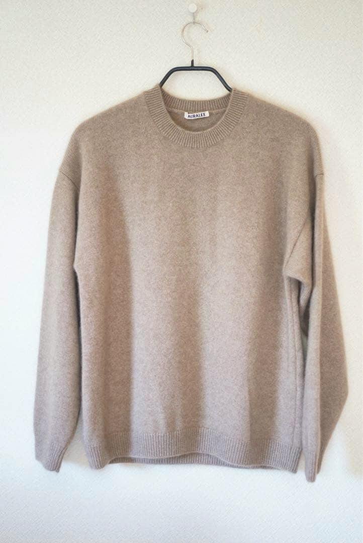 Front view of the baby cashmere knit pullover (size 3) hanging on a hanger.
