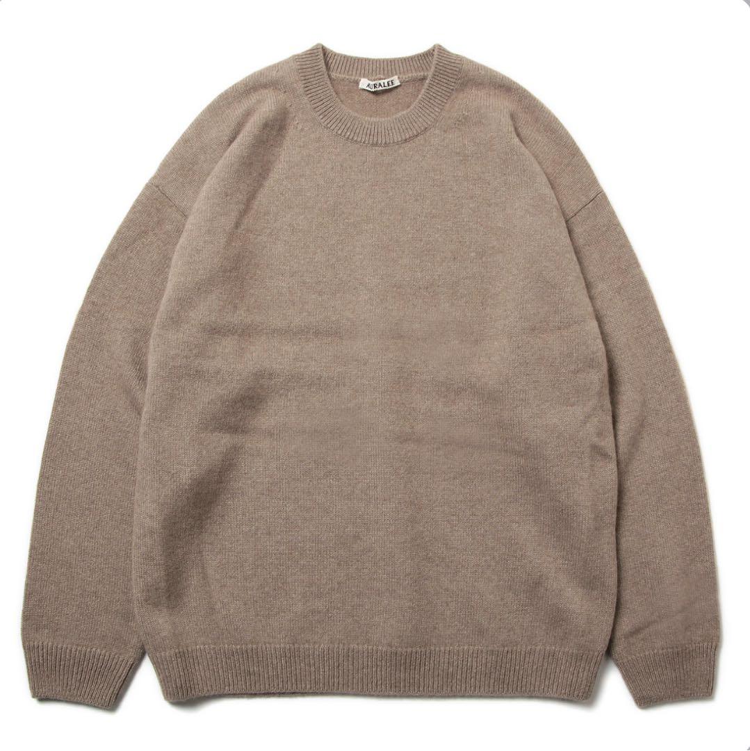 Beige crewneck AURALEE baby cashmere knit sweater laid flat showing the front.