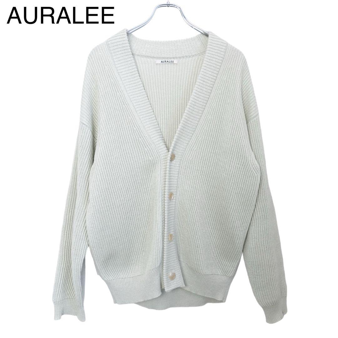 Front view of an AURALEE hemp rib-knit box cardigan in a light color hanging on a hanger.
