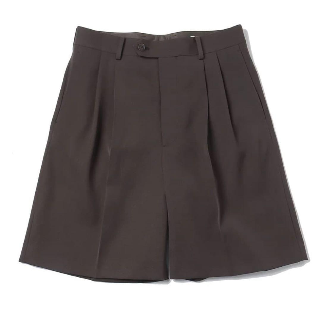 Flat-lay wool shorts with front pleats and belt loops on a white background.