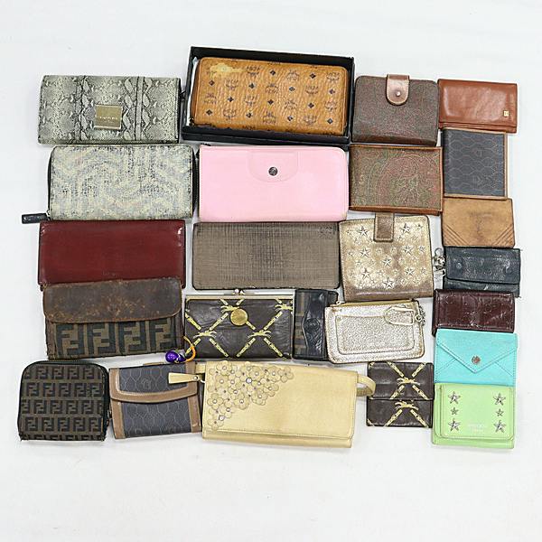 Multiple wallets and small leather accessories arranged on a white background.