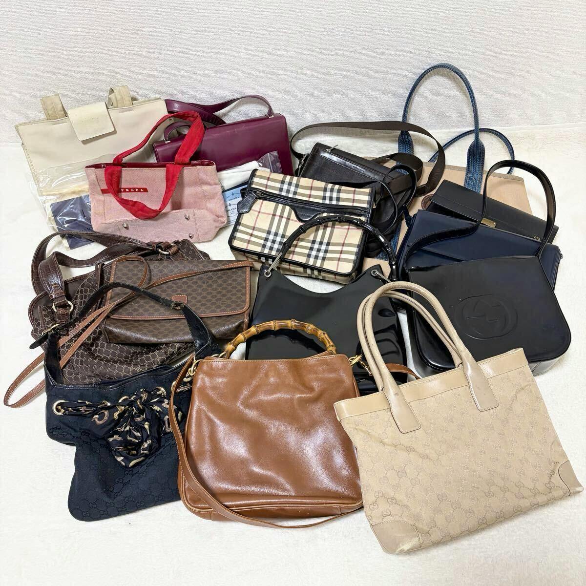 A pile of assorted handbags and totes arranged on a light surface, showing a bulk set of bags.
