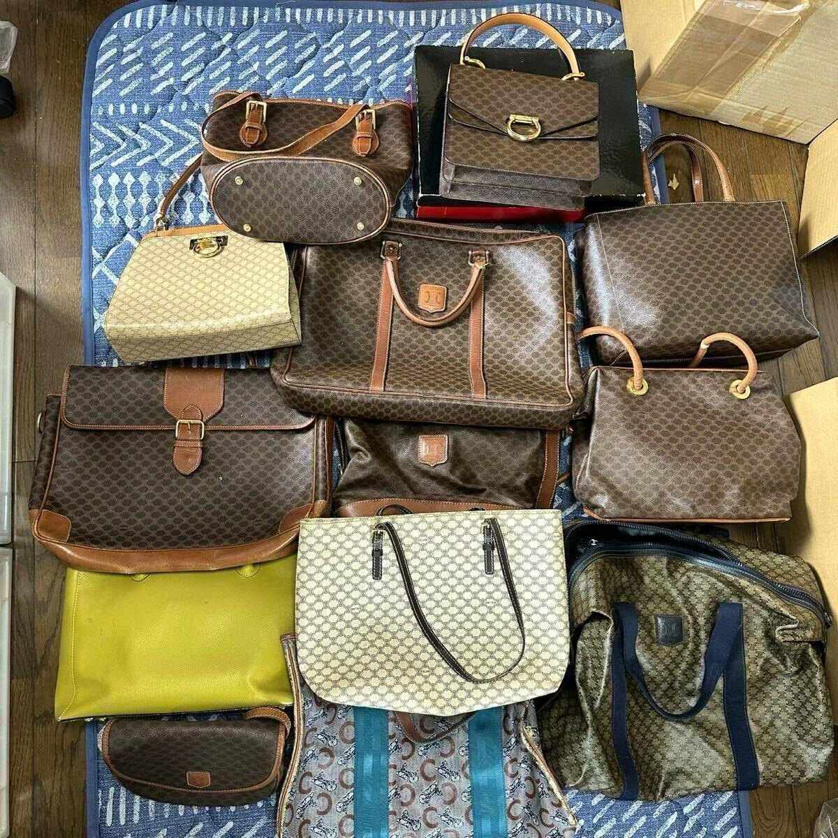 Top-down photo of multiple CELINE macadam-pattern bags and pouches, including totes and shoulder bags, arranged on a rug.