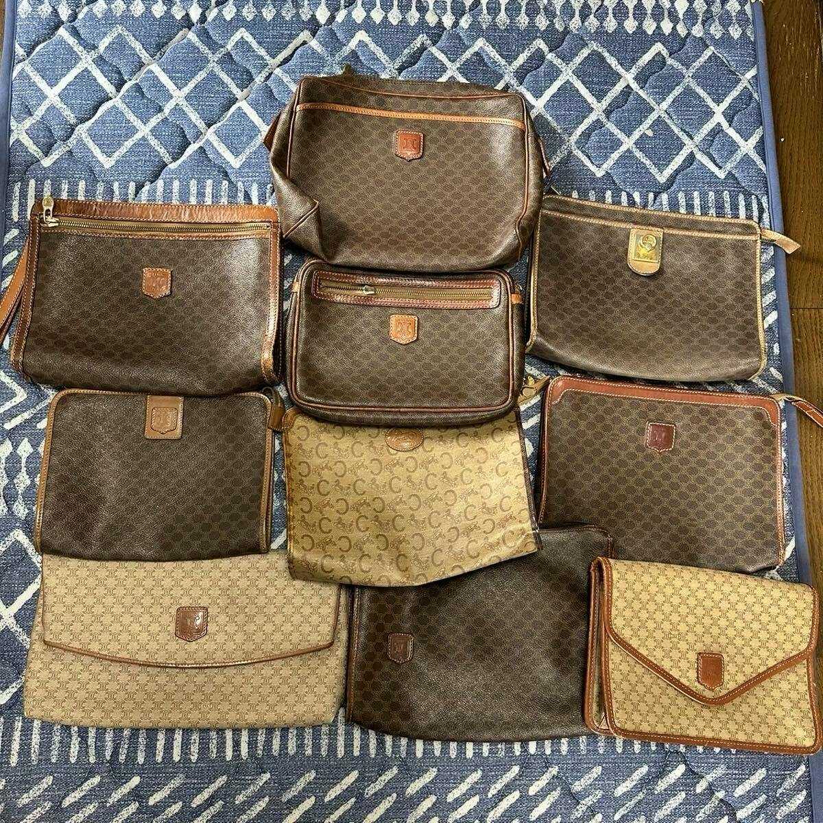 Several brown CELINE macadam-pattern clutch and second bags arranged on a blue rug.