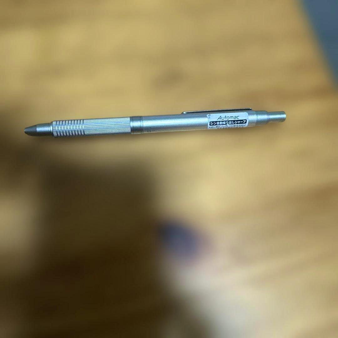 Silver Pilot Automac 0.5mm mechanical pencil resting on a wooden surface.