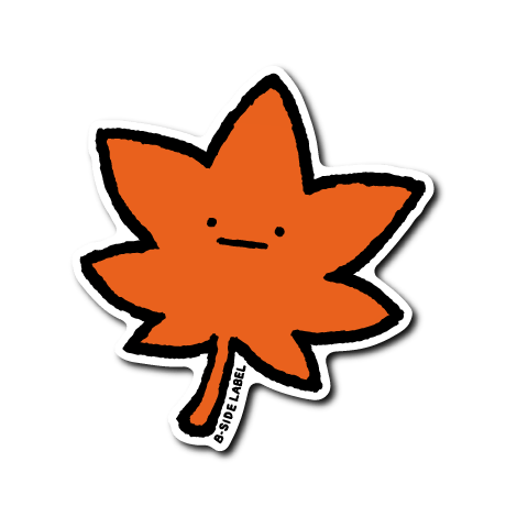 Paper sticker depicting a red maple leaf with a small neutral face and a white border.