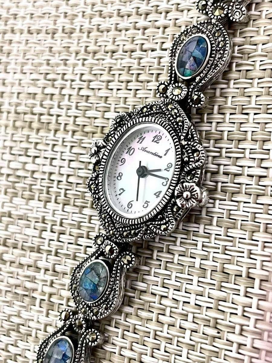 Close-up of the Avantino wristwatch face and decorative bracelet showing opal-like oval insets and marcasite-style Art Deco metalwork.