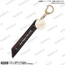Ribbon-style keychain with a metal clasp and a round acrylic charm, featuring printed commemorative text.