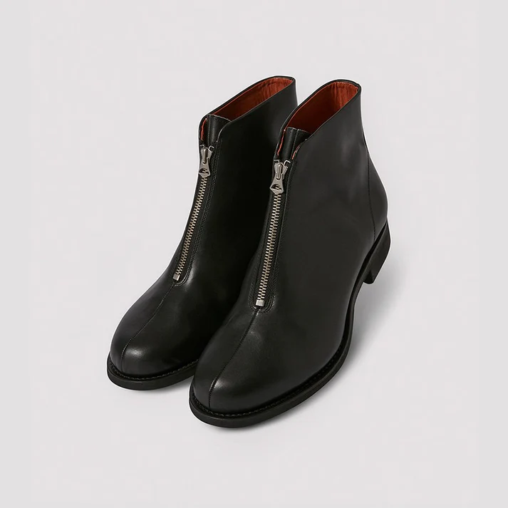Pair of black aviator zip leather ankle boots shown from a front three-quarter view with visible front zippers on a light background.