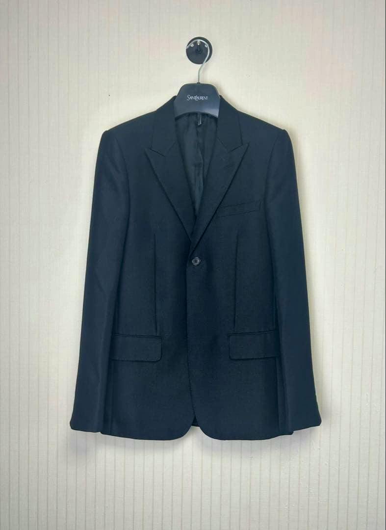 Front view of the men's wool notch-lapel tailored jacket (size 46) hanging on a hanger.