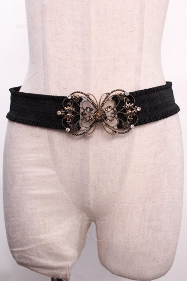 Black elastic belt with an ornate metal decorative buckle displayed on a mannequin torso.