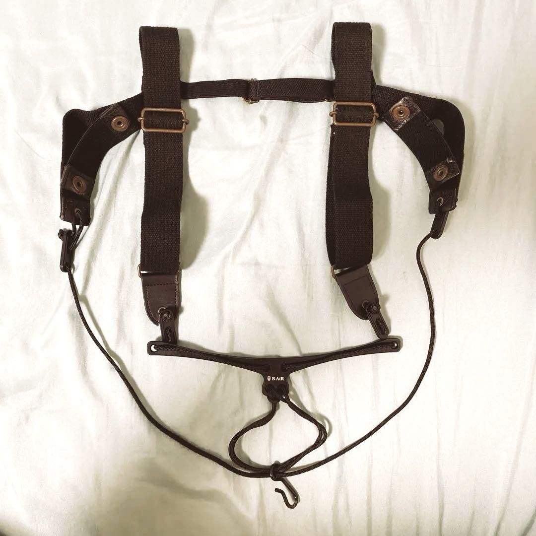 B.AIR bird shoulder strap for bassoon laid flat on a light surface.