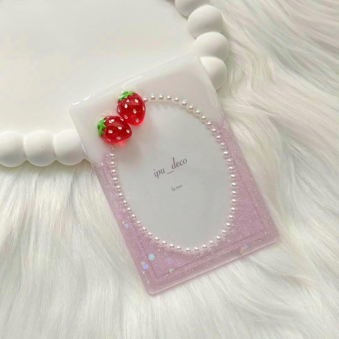 Pink glitter B8 hard plastic card case decorated with two red resin strawberries and a ring of small pearls around a white insert.