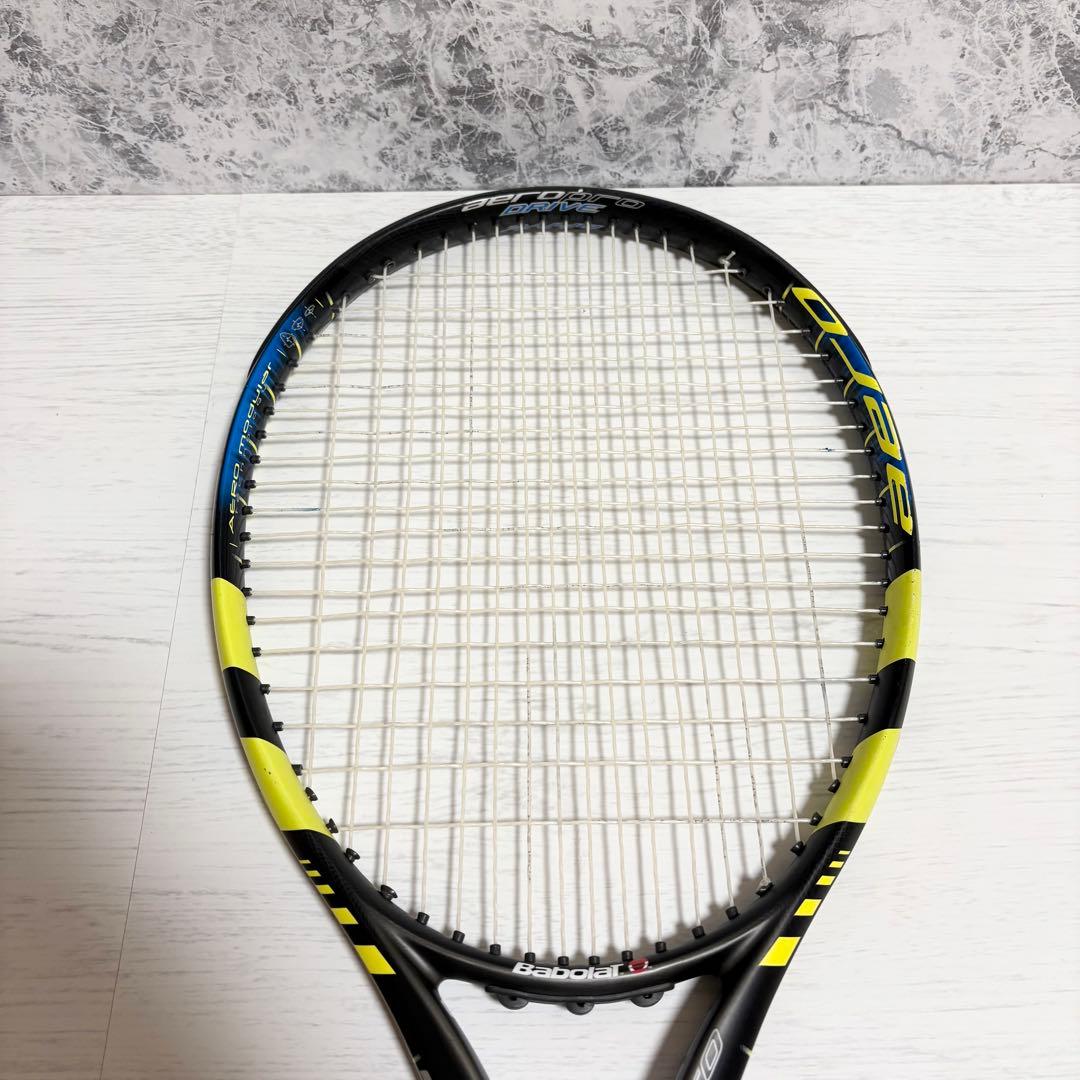 Top-down photo of the Babolat Aeropro Drive (2004) tennis racket showing the strung head and yellow-and-black frame.