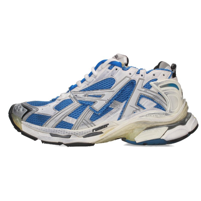 Side view of a blue Balenciaga RUNNER men's sneaker showing mesh upper and layered sole.