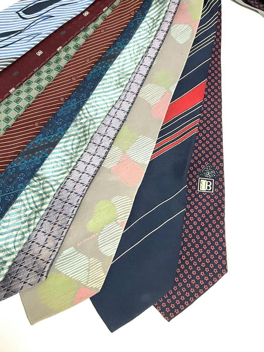 Several silk neckties with various stripe and patterned designs laid flat on a white background.