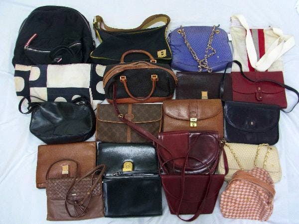 Photo of multiple Bally and other handbags, tote bags, and shoulder bags arranged on a white surface as a bundled set.
