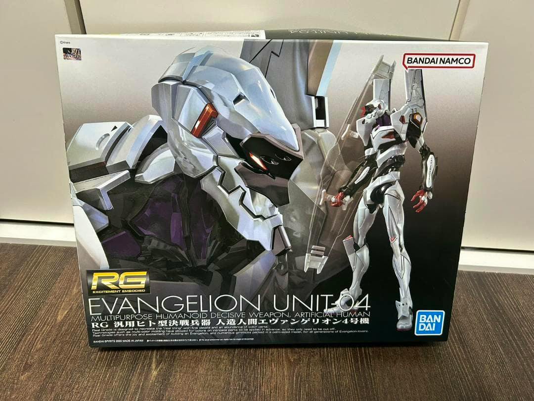 Photograph of the box for the BANDAI RG 1/144 Evangelion Unit-04 model kit showing the kit's box art depicting Evangelion Unit-04.