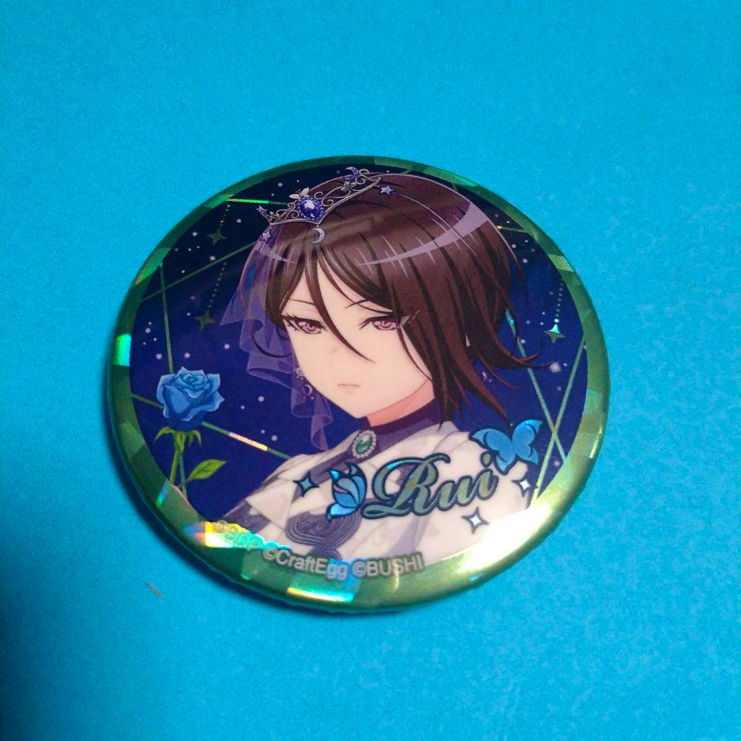 Front photo of the バンドリ 八潮瑠唯 缶バッジ showing the illustrated character's face on a blue background.