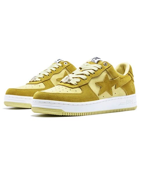 Pair of yellow BAPE STA #3 M sneakers on a white background.