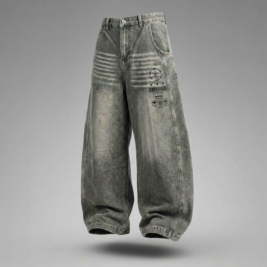 Front view of men's denim pants with faded gray wash and barcode-style printed graphics on the right thigh against a neutral gray background.