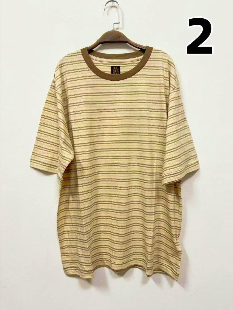 Front view of the BATONER hand-drawing border T-shirt (size 2) hanging on a hanger against a white wall.