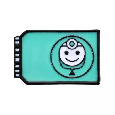 A turquoise rectangular enamel pin badge showing a smiling healthcare-chip icon outlined in black on a white background.