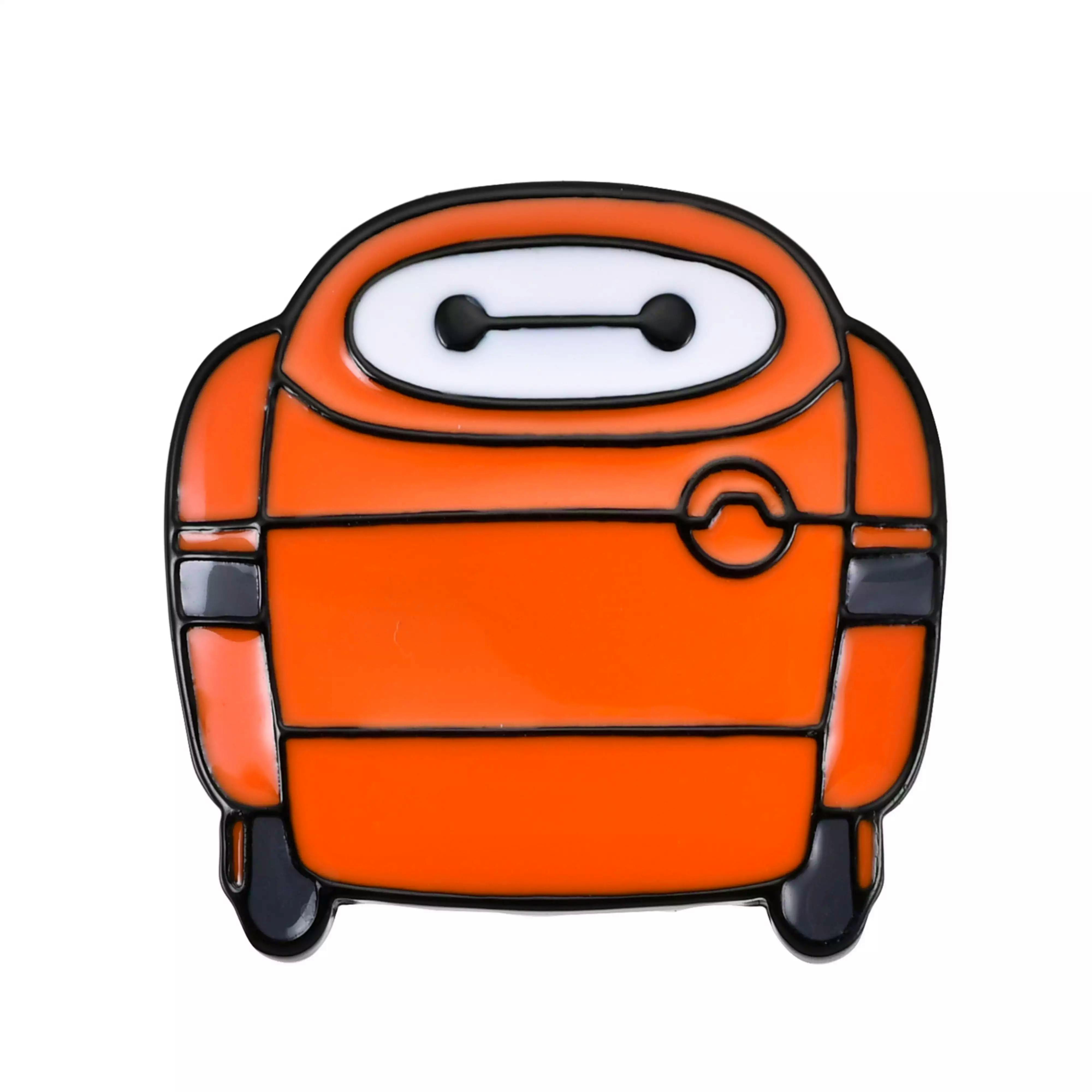 Close-up photo of an orange Baymax pin badge showing the character's face and upper body.
