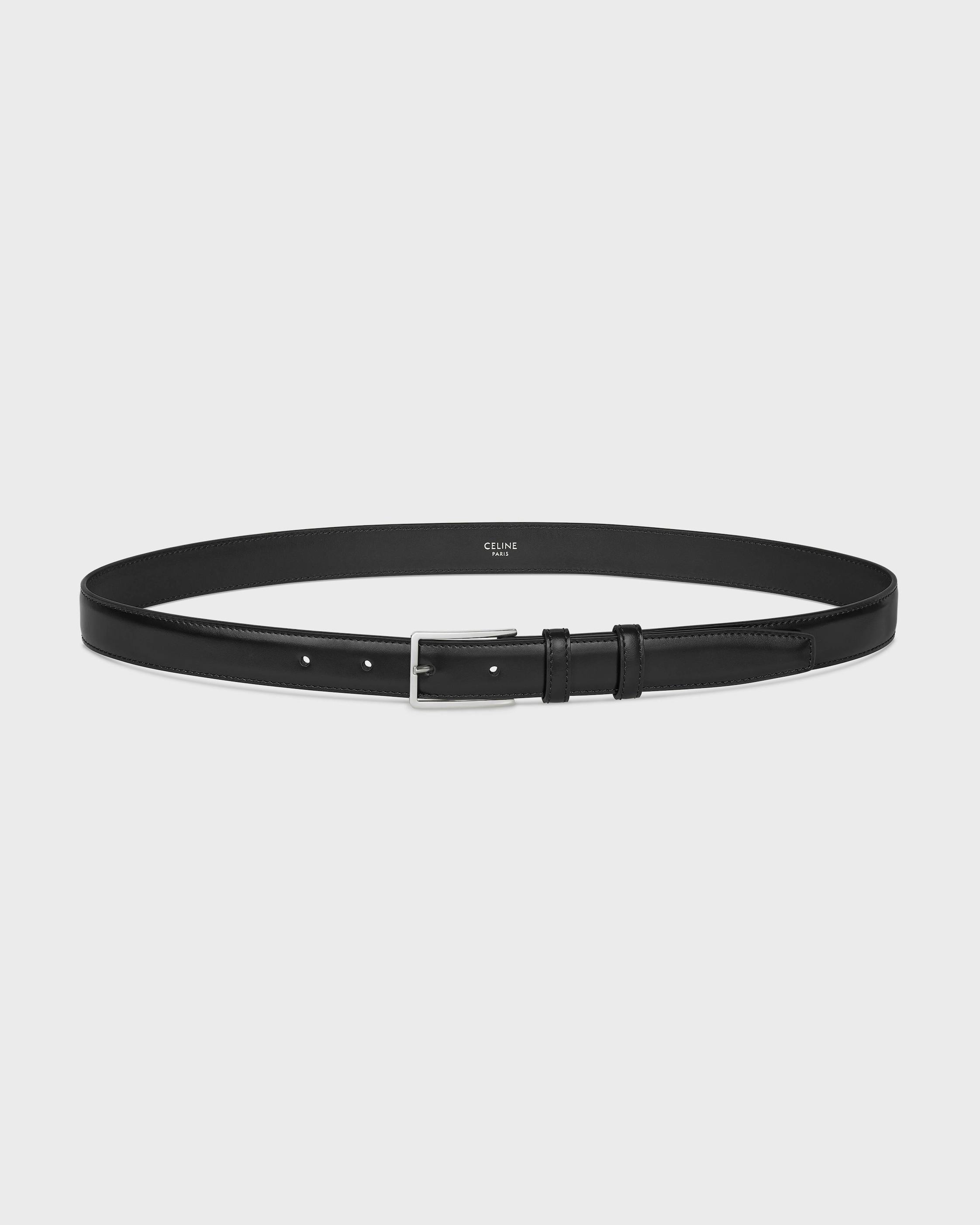 Black 25mm cow leather belt shown looped with a silver buckle and interior "CELINE PARIS" stamp.