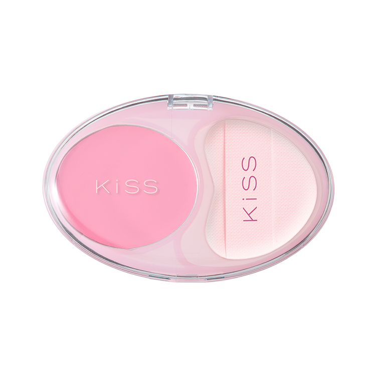 Oval pink compact blush with a matching applicator sponge and KISS branding on a white background.