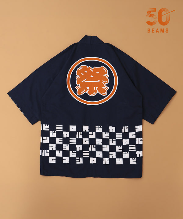Back view of the Beams Japan happi coat laid flat, navy with an orange circular kanji motif and white checkerboard band.