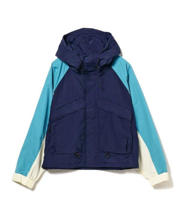 Front view of a men's nylon BEAMS hooded jacket in navy with light blue sleeves and cream cuffs laid flat on a white background.