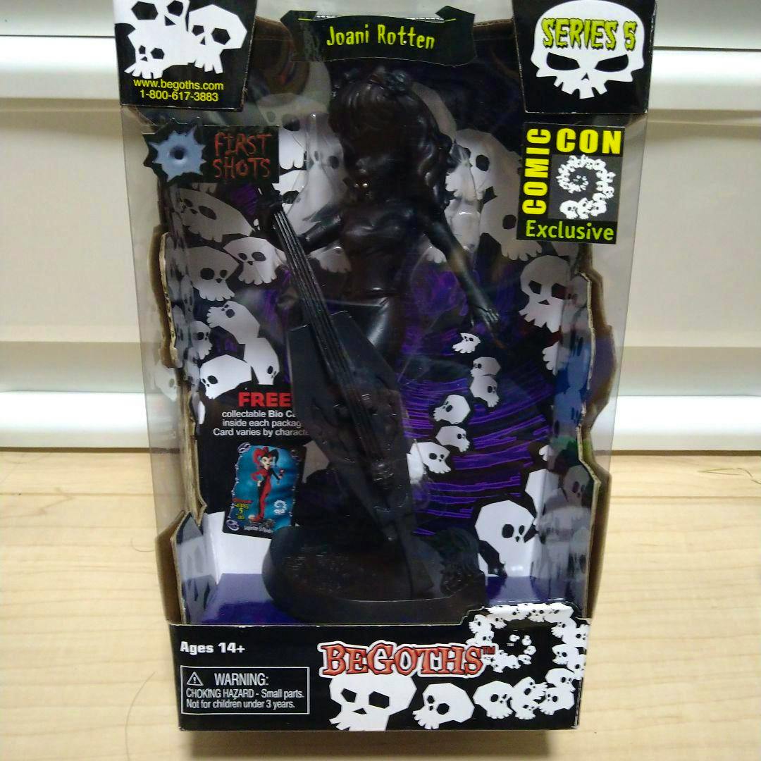 Front view of a boxed BEGOTHS Series 5 Comic Con exclusive figure in its retail packaging with skull-patterned backing.