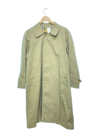 Beige cotton women's trench coat shown from the front hanging on a hanger.