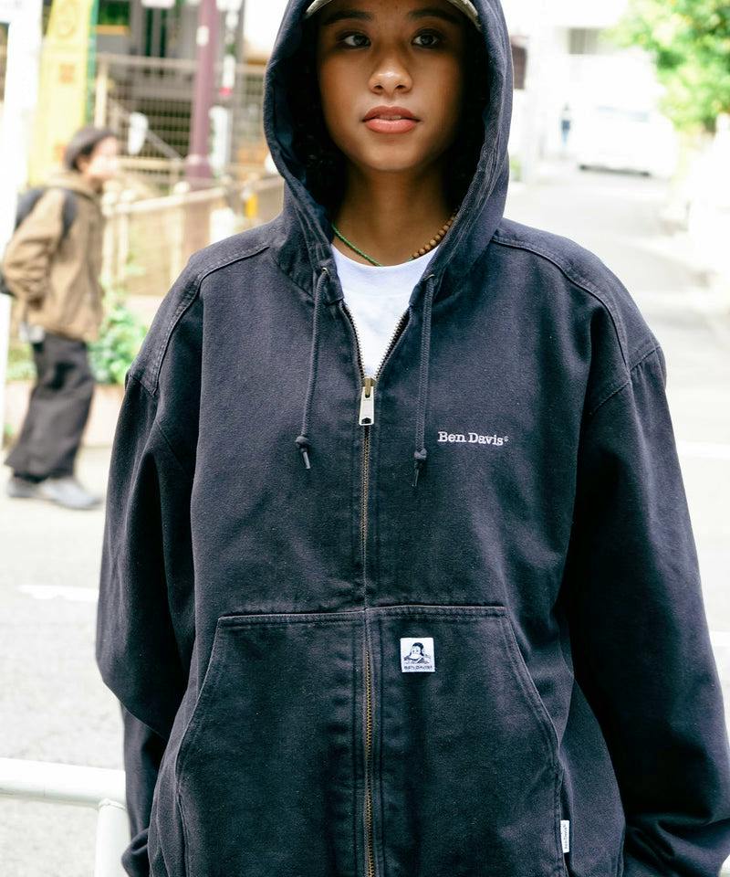 Person wearing a black Ben Davis hooded zip-up parka showing the front logo and kangaroo pocket.